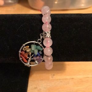 Pink beaded bracelet with stone and silver tone tree of life charm